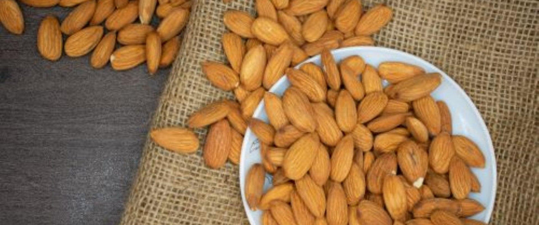 Almonds spilling over a bowl