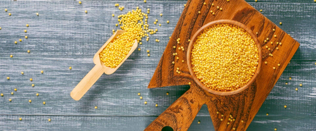 A bowl of millets next to a small scooper
