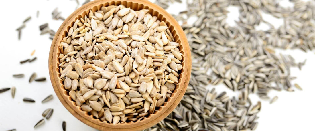 Sunflower seeds spilling over a bowl
