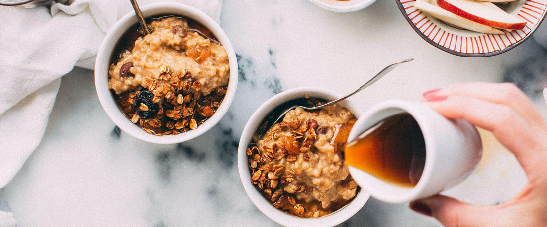 Two bowls of food with liquid being poured over from a jug