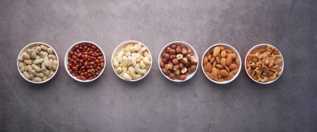 Bowls of various nuts in a line